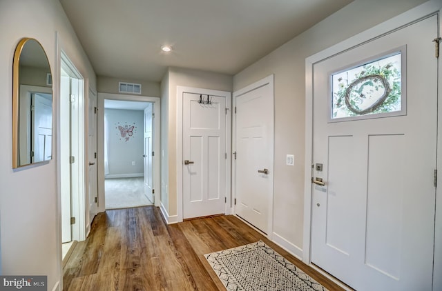 entrance foyer featuring wood finished floors, visible vents, and baseboards