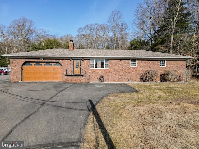 view of property exterior with brick siding, a chimney, a garage, and roof with shingles