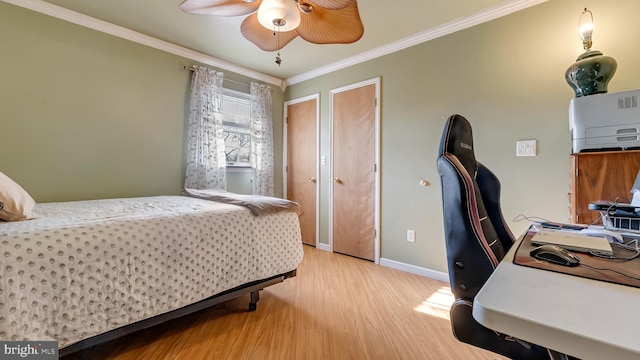 bedroom with light wood-style flooring, baseboards, and ornamental molding