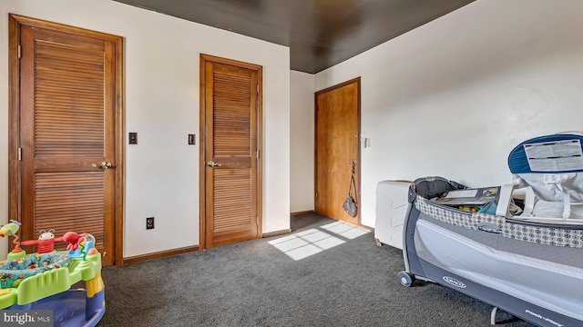 carpeted bedroom featuring baseboards