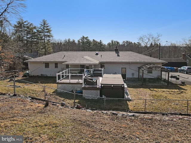 back of house with a fenced backyard, a chimney, and a deck