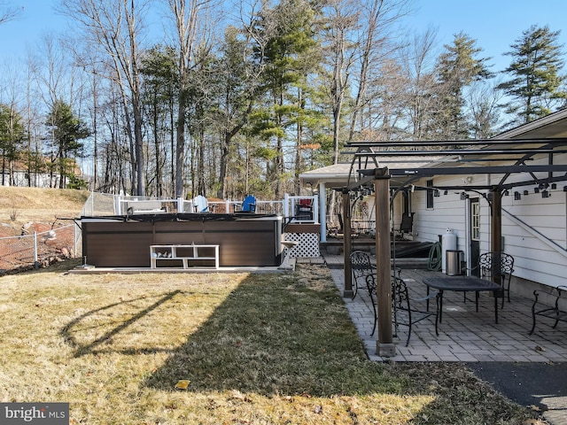 view of yard featuring a patio area, fence, and a hot tub