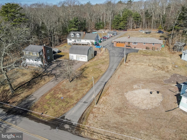 birds eye view of property with a wooded view