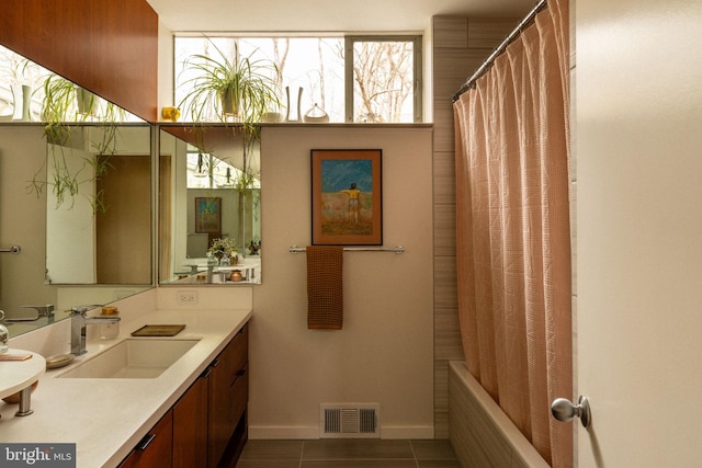 full bathroom featuring shower / bath combination with curtain, visible vents, vanity, baseboards, and tile patterned floors