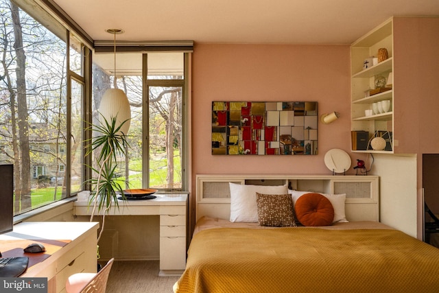 bedroom featuring wood finished floors and multiple windows