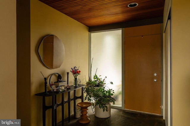 entryway featuring baseboards and wooden ceiling