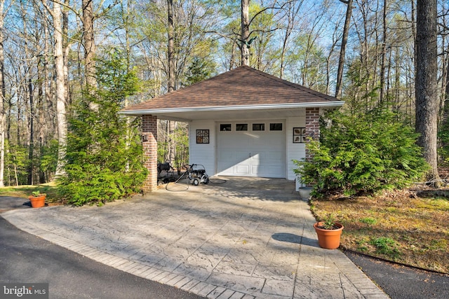 garage featuring concrete driveway and a garage