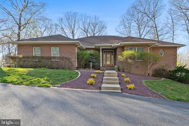 view of front of property with brick siding and a front yard