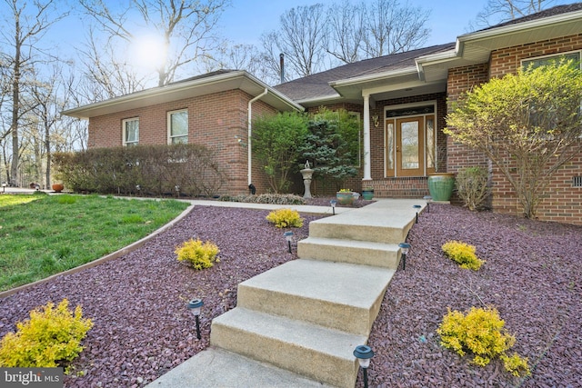 property entrance featuring brick siding
