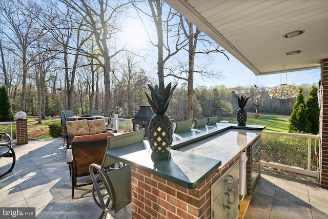 view of patio with outdoor wet bar and exterior kitchen