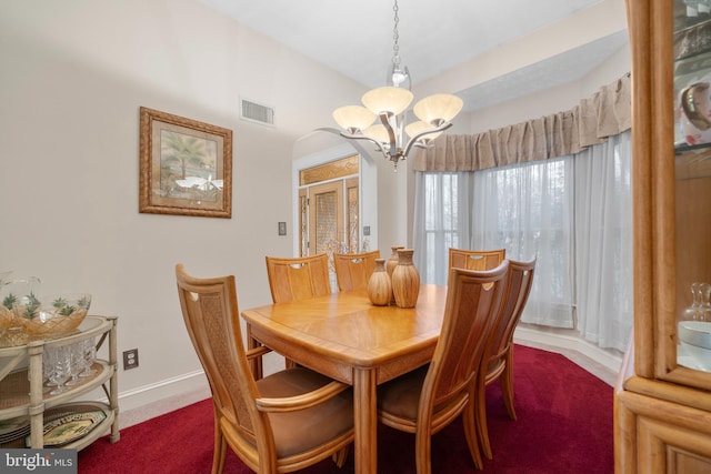 dining room with baseboards, visible vents, carpet floors, and a chandelier