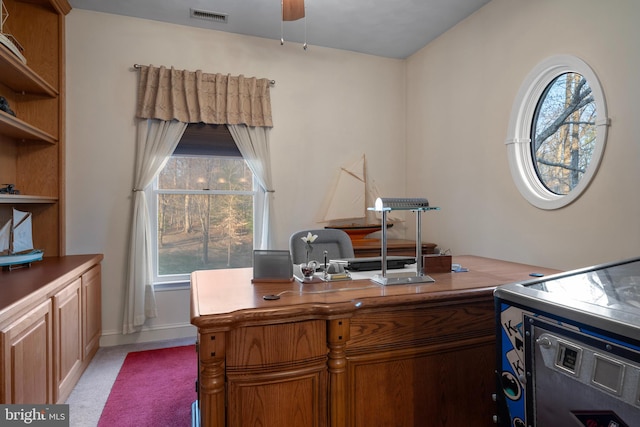 office space with visible vents, a wealth of natural light, and ceiling fan