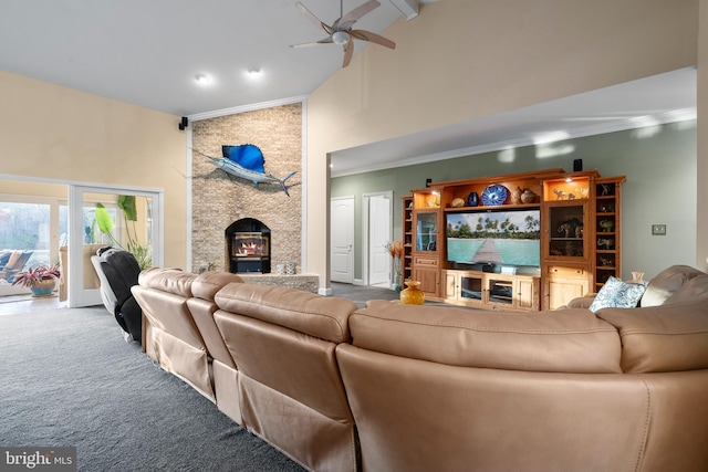 carpeted living room featuring high vaulted ceiling, ornamental molding, a ceiling fan, and a fireplace