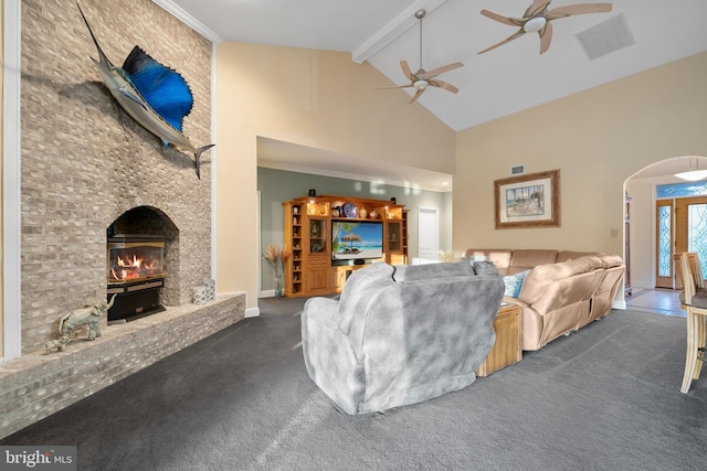 carpeted living area with beam ceiling, arched walkways, visible vents, a ceiling fan, and high vaulted ceiling
