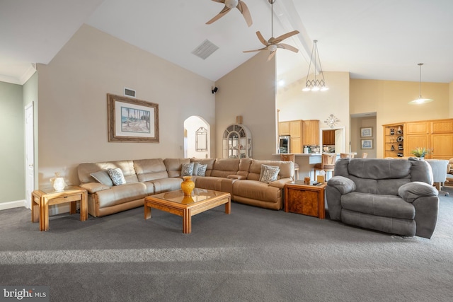 carpeted living room with arched walkways, a ceiling fan, visible vents, and high vaulted ceiling