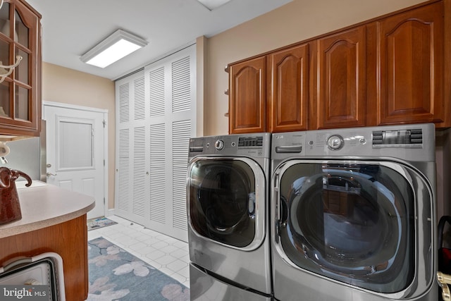 laundry room with cabinet space and washer and clothes dryer