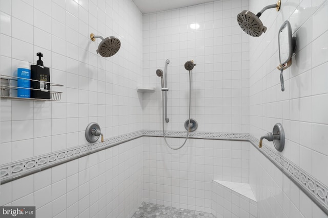 full bath with a tile shower
