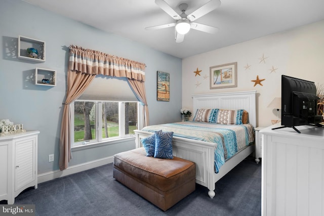 bedroom with a ceiling fan, baseboards, and dark carpet