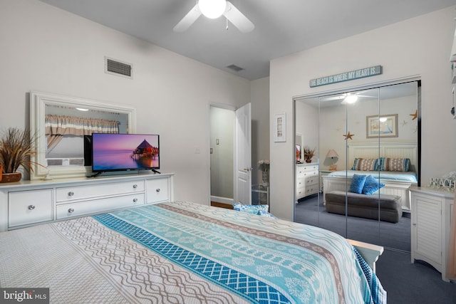 bedroom featuring carpet floors, a ceiling fan, visible vents, and a closet