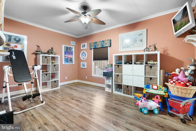 interior space featuring a ceiling fan, ornamental molding, wood finished floors, and visible vents