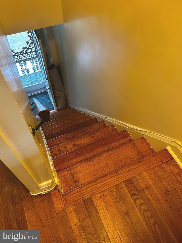 2834 Edgecombe Cir S, Baltimore, MD 21215 - staircase with baseboards and hardwood / wood-style floors