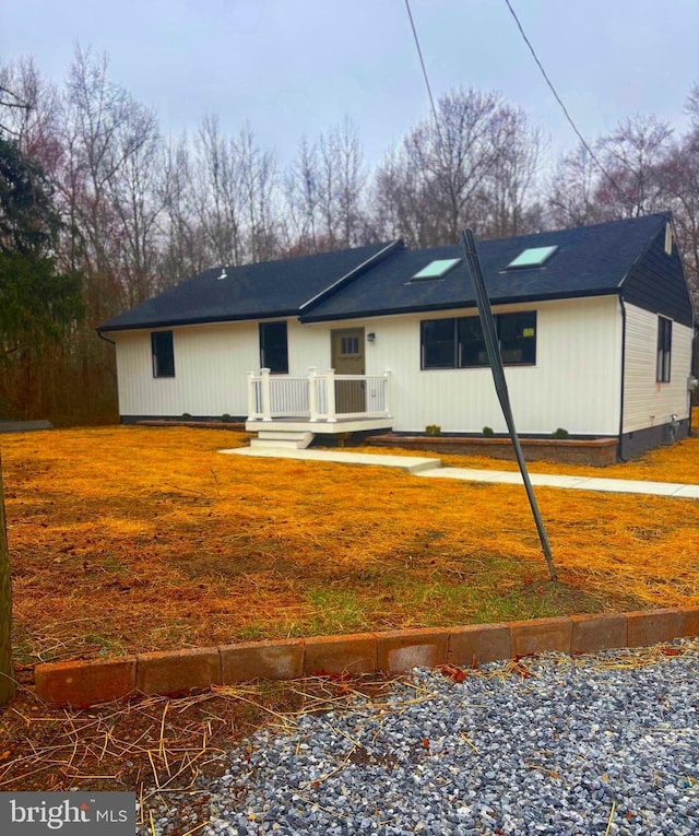 ranch-style home featuring a deck, a front lawn, and crawl space