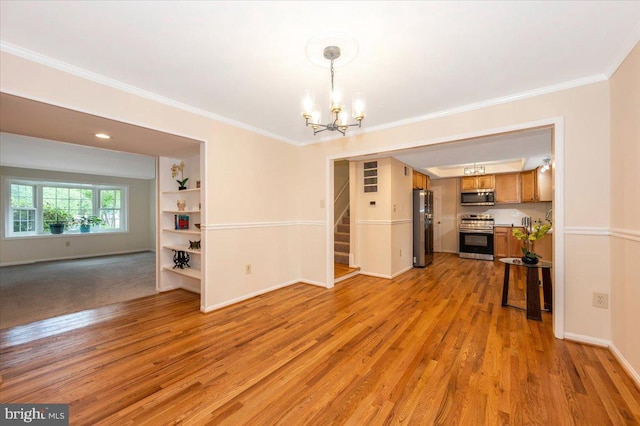 unfurnished dining area with a chandelier, ornamental molding, light wood-type flooring, stairs, and baseboards