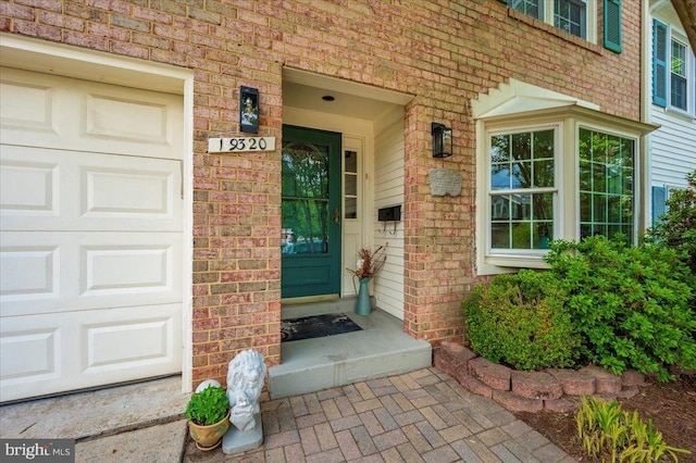 entrance to property featuring brick siding