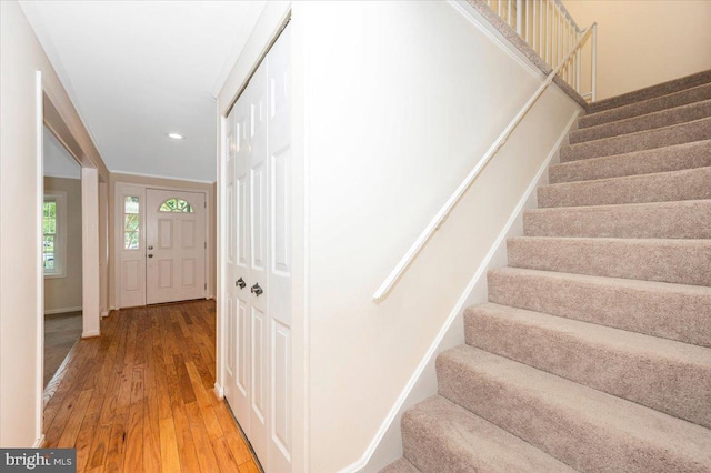 staircase with wood-type flooring and recessed lighting