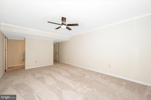 unfurnished room with a ceiling fan, crown molding, light carpet, and baseboards