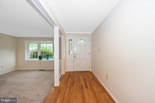 foyer entrance featuring baseboards and light wood-style floors