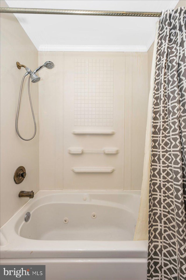 bathroom with ornamental molding and shower / tub combo