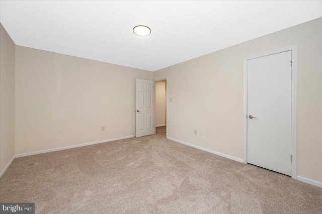 unfurnished bedroom featuring carpet flooring and baseboards