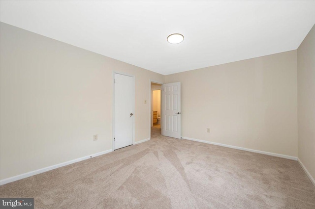 unfurnished bedroom featuring carpet flooring and baseboards