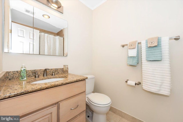 full bathroom with toilet, vanity, tile patterned flooring, and baseboards