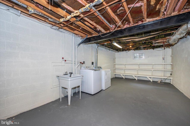 unfinished basement with independent washer and dryer and concrete block wall