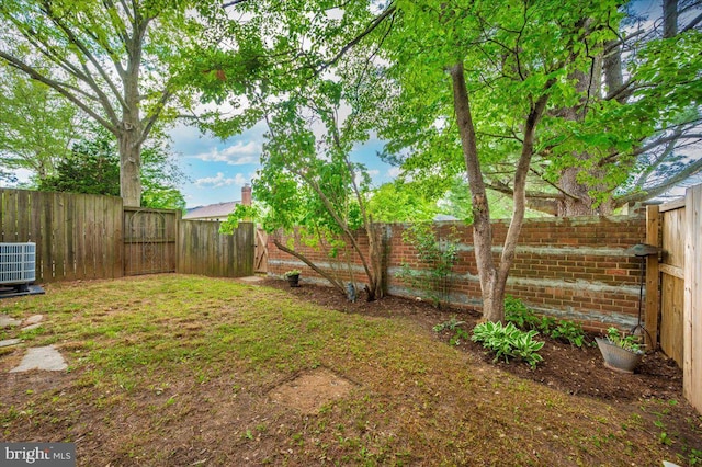 fenced backyard with central AC unit