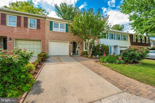 view of property with driveway, brick siding, and an attached garage