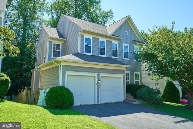 view of home's exterior with aphalt driveway, a shingled roof, a garage, and fence