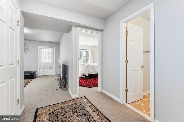carpeted foyer entrance with baseboards
