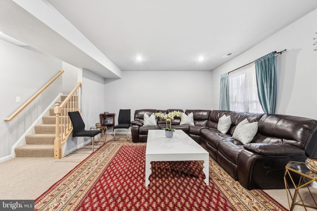 living area featuring stairway, visible vents, baseboards, recessed lighting, and light colored carpet