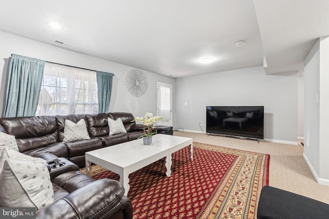 carpeted living area with visible vents and baseboards