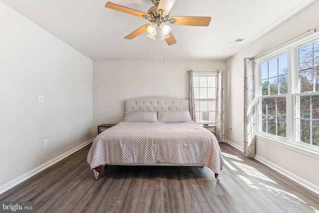 bedroom featuring visible vents, baseboards, and wood finished floors