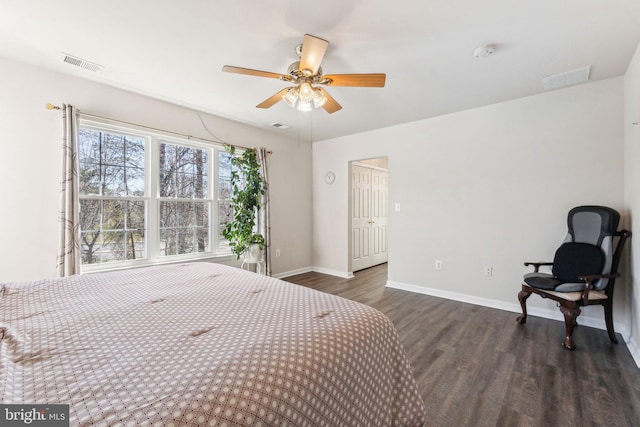 bedroom featuring visible vents, baseboards, and wood finished floors