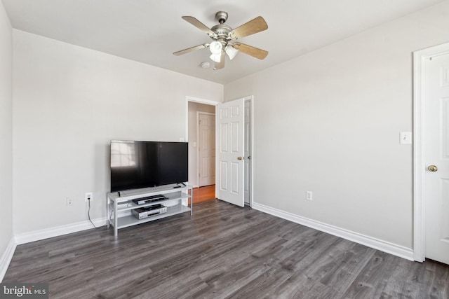 unfurnished living room with wood finished floors, baseboards, and ceiling fan