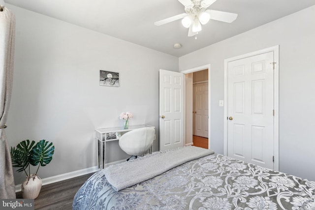 bedroom with dark wood finished floors, a ceiling fan, and baseboards