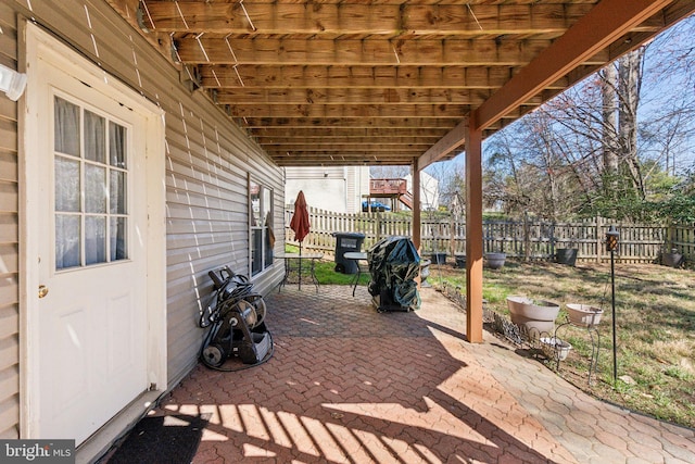 view of patio / terrace featuring fence