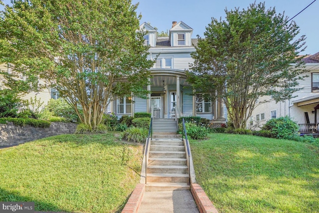 1033 Newton St NE, Washington, DC 20017 - view of front of property featuring a front yard, covered porch, stairs, and a chimney