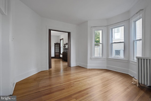 1033 Newton St NE, Washington, DC 20017 - unfurnished room with light wood finished floors and radiator heating unit