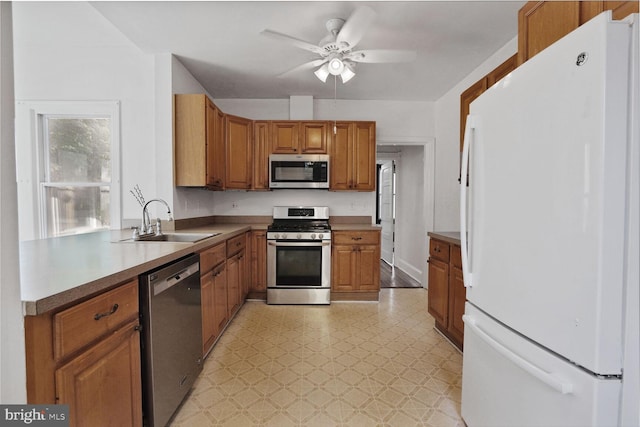 1033 Newton St NE, Washington, DC 20017 - kitchen with stainless steel appliances, light flooring, a ceiling fan, and brown cabinetry